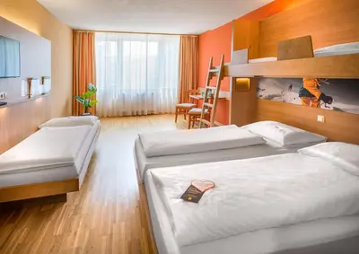 Ein Bett oder Betten in einem Zimmer der Unterkunft JUFA Hotel Altenmarkt-Zauchensee