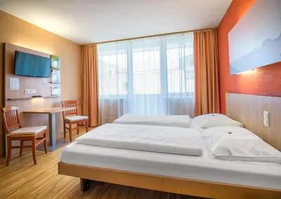 Ein Bett oder Betten in einem Zimmer der Unterkunft JUFA Hotel Altenmarkt-Zauchensee