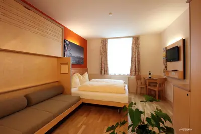 Ein Bett oder Betten in einem Zimmer der Unterkunft JUFA Hotel Altenmarkt-Zauchensee