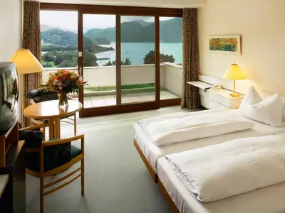 Ein Bett oder Betten in einem Zimmer der Unterkunft Landzeit Motor-Hotel Mondsee