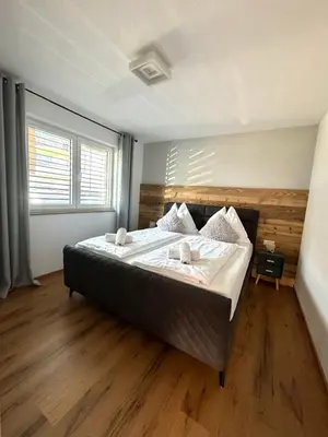 Ein Bett oder Betten in einem Zimmer der Unterkunft Alpin Apartments