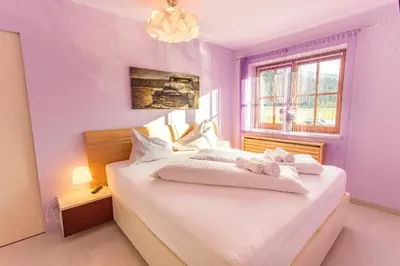 Ein Bett oder Betten in einem Zimmer der Unterkunft Sunshine Aich by Alpenidyll Apartments