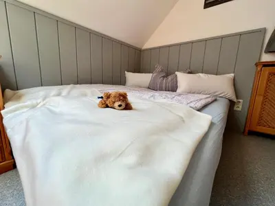 Ein Bett oder Betten in einem Zimmer der Unterkunft Ferienwohnung Martens Villa
