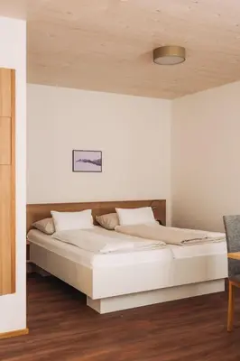 Ein Bett oder Betten in einem Zimmer der Unterkunft MANGGEI-BAU Appartements und Studios