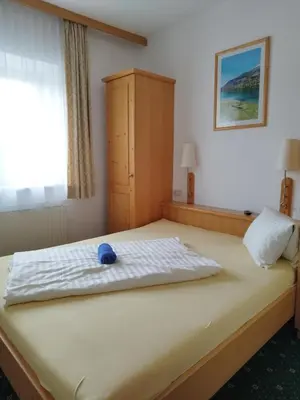 Ein Bett oder Betten in einem Zimmer der Unterkunft Hotel Pension Kandolf
