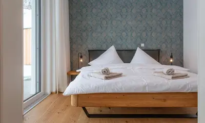 Ein Bett oder Betten in einem Zimmer der Unterkunft Seepanorama Apartments am Grundlsee - Your Austrian Home