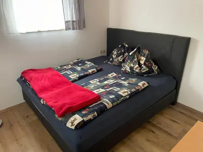 Ein Bett oder Betten in einem Zimmer der Unterkunft Ferienwohnung in ruhiger Lage in Bischofshofen