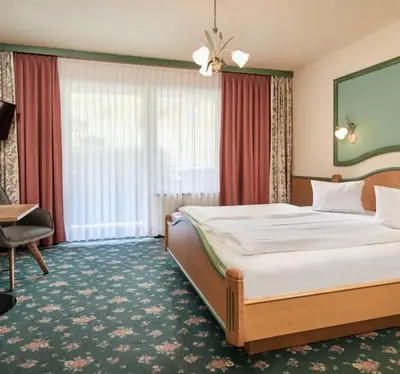 Ein Bett oder Betten in einem Zimmer der Unterkunft Hotel Bergglück
