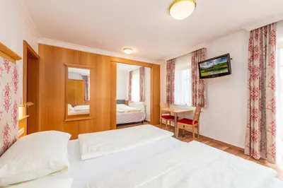 Ein Bett oder Betten in einem Zimmer der Unterkunft Reisslerhof Hotel & Apartments - by myNests