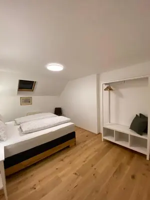 Ein Bett oder Betten in einem Zimmer der Unterkunft Suite am Attwengerhof