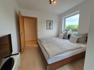 Ein Bett oder Betten in einem Zimmer der Unterkunft Apartment East