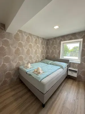 Ein Bett oder Betten in einem Zimmer der Unterkunft SUNSET RESIDENCE Attersee
