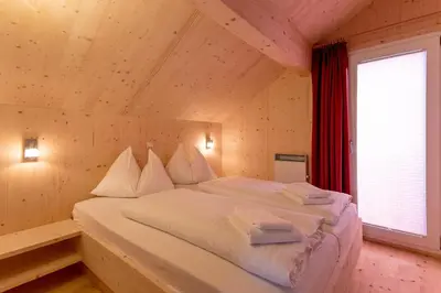 Ein Bett oder Betten in einem Zimmer der Unterkunft Woody Park Feriendorf Murau