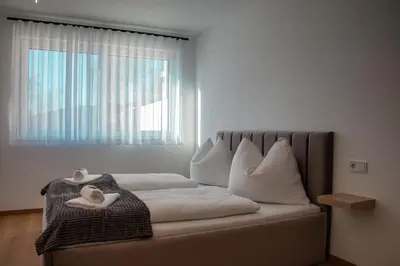 Ein Bett oder Betten in einem Zimmer der Unterkunft Alpen Sky Apartments