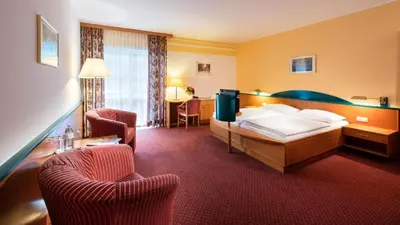 Ein Bett oder Betten in einem Zimmer der Unterkunft EVIVA im Parkhotel