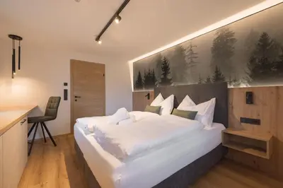 Ein Bett oder Betten in einem Zimmer der Unterkunft Hochthron Suites