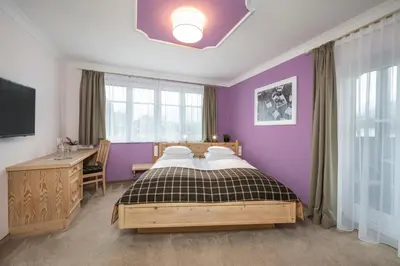 Ein Bett oder Betten in einem Zimmer der Unterkunft Hotel Garni Carl Michael
