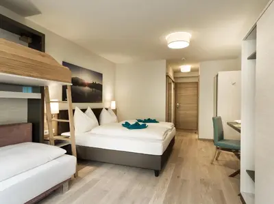 Ein Bett oder Betten in einem Zimmer der Unterkunft Hotel Sportwelt