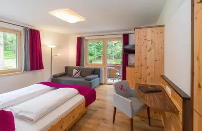 Ein Bett oder Betten in einem Zimmer der Unterkunft Hotel Rösslhof
