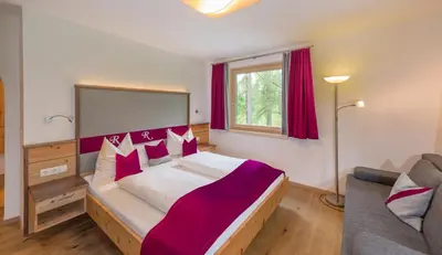 Ein Bett oder Betten in einem Zimmer der Unterkunft Hotel Rösslhof