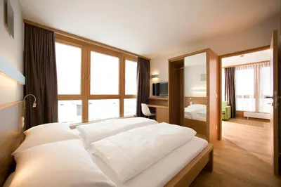 Ein Bett oder Betten in einem Zimmer der Unterkunft Hotel Manggei Designhotel Obertauern