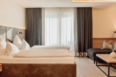 Ein Bett oder Betten in einem Zimmer der Unterkunft Alpina Alpendorf