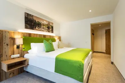 Ein Bett oder Betten in einem Zimmer der Unterkunft Alpenhotel Wurzer