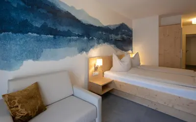 Ein Bett oder Betten in einem Zimmer der Unterkunft Familienhotel Botenwirt