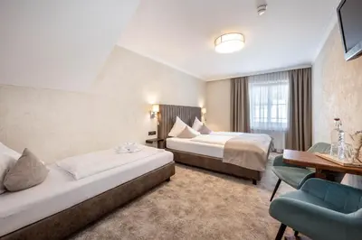Ein Bett oder Betten in einem Zimmer der Unterkunft Hotel Stegerbräu