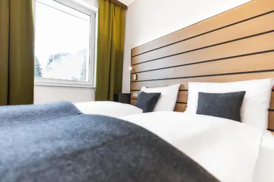 Ein Bett oder Betten in einem Zimmer der Unterkunft JUFA Hotel Schladming