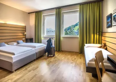 Ein Bett oder Betten in einem Zimmer der Unterkunft JUFA Hotel Schladming