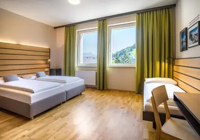Ein Bett oder Betten in einem Zimmer der Unterkunft JUFA Hotel Schladming