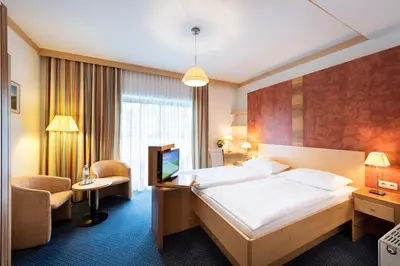 Ein Bett oder Betten in einem Zimmer der Unterkunft Parkhotel zur Klause