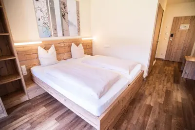 Ein Bett oder Betten in einem Zimmer der Unterkunft COOEE alpin Hotel Dachstein