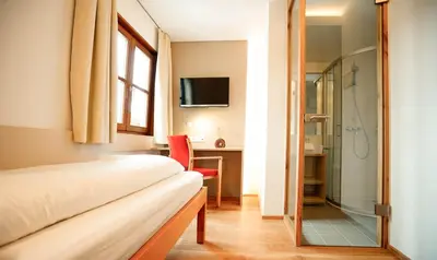 Ein Bett oder Betten in einem Zimmer der Unterkunft SPES Hotel & Seminare