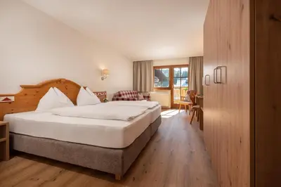 Ein Bett oder Betten in einem Zimmer der Unterkunft Hotel am Sonnenhügel