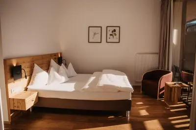 Ein Bett oder Betten in einem Zimmer der Unterkunft Hotel Neubergerhof