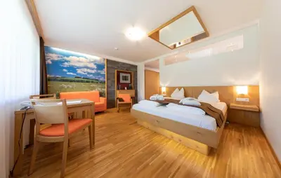 Ein Bett oder Betten in einem Zimmer der Unterkunft Almfrieden Hotel & Romantikchalet