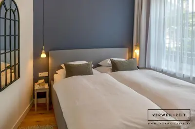 Ein Bett oder Betten in einem Zimmer der Unterkunft Verweilzeit Appartementhaus