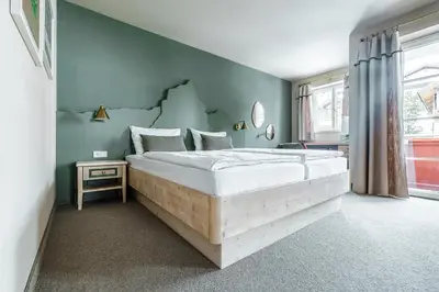 Ein Bett oder Betten in einem Zimmer der Unterkunft Apparthotel Sankt Georg