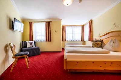 Ein Bett oder Betten in einem Zimmer der Unterkunft Hotel Breitlehenalm