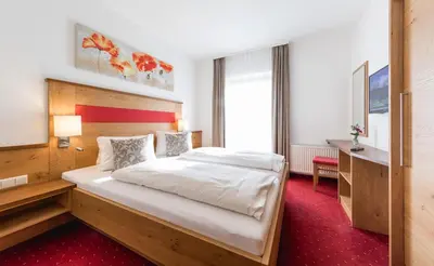 Ein Bett oder Betten in einem Zimmer der Unterkunft Landhaus Rosengartl
