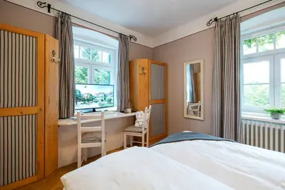 Ein Bett oder Betten in einem Zimmer der Unterkunft TAUROA Landhaus zu Appesbach