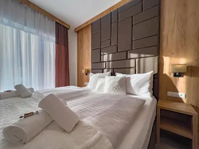 Ein Bett oder Betten in einem Zimmer der Unterkunft Sylpaulerhof Aparthotel