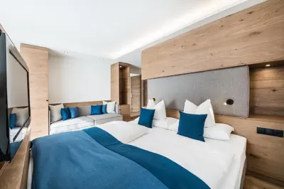 Ein Bett oder Betten in einem Zimmer der Unterkunft Superior Hotel Alpenhof
