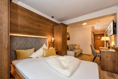 Ein Bett oder Betten in einem Zimmer der Unterkunft Hotel Alpenhof Superior