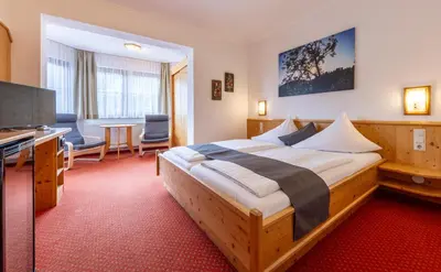 Ein Bett oder Betten in einem Zimmer der Unterkunft ApartHotel Holzerhof