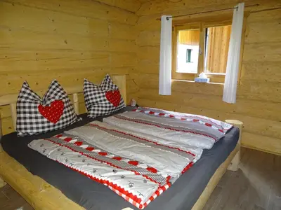 Ein Bett oder Betten in einem Zimmer der Unterkunft C.T.N. Loghouse