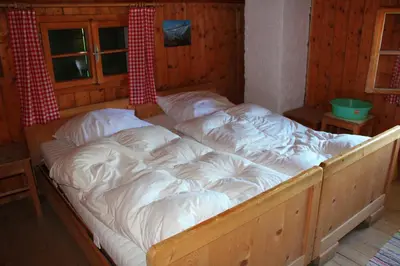 Ein Bett oder Betten in einem Zimmer der Unterkunft Draugstein - Hütte
