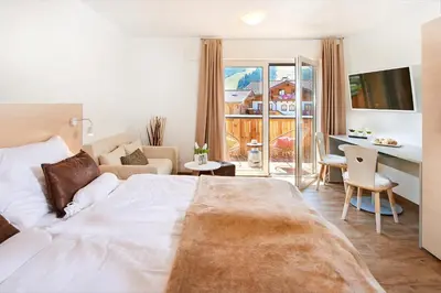 Ein Bett oder Betten in einem Zimmer der Unterkunft AlpinLodge Flachau